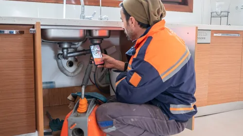 A person clicking picture of damaged pipe