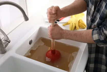 Sink clogged, being cleaned