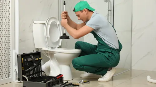 A person cleaning toilet